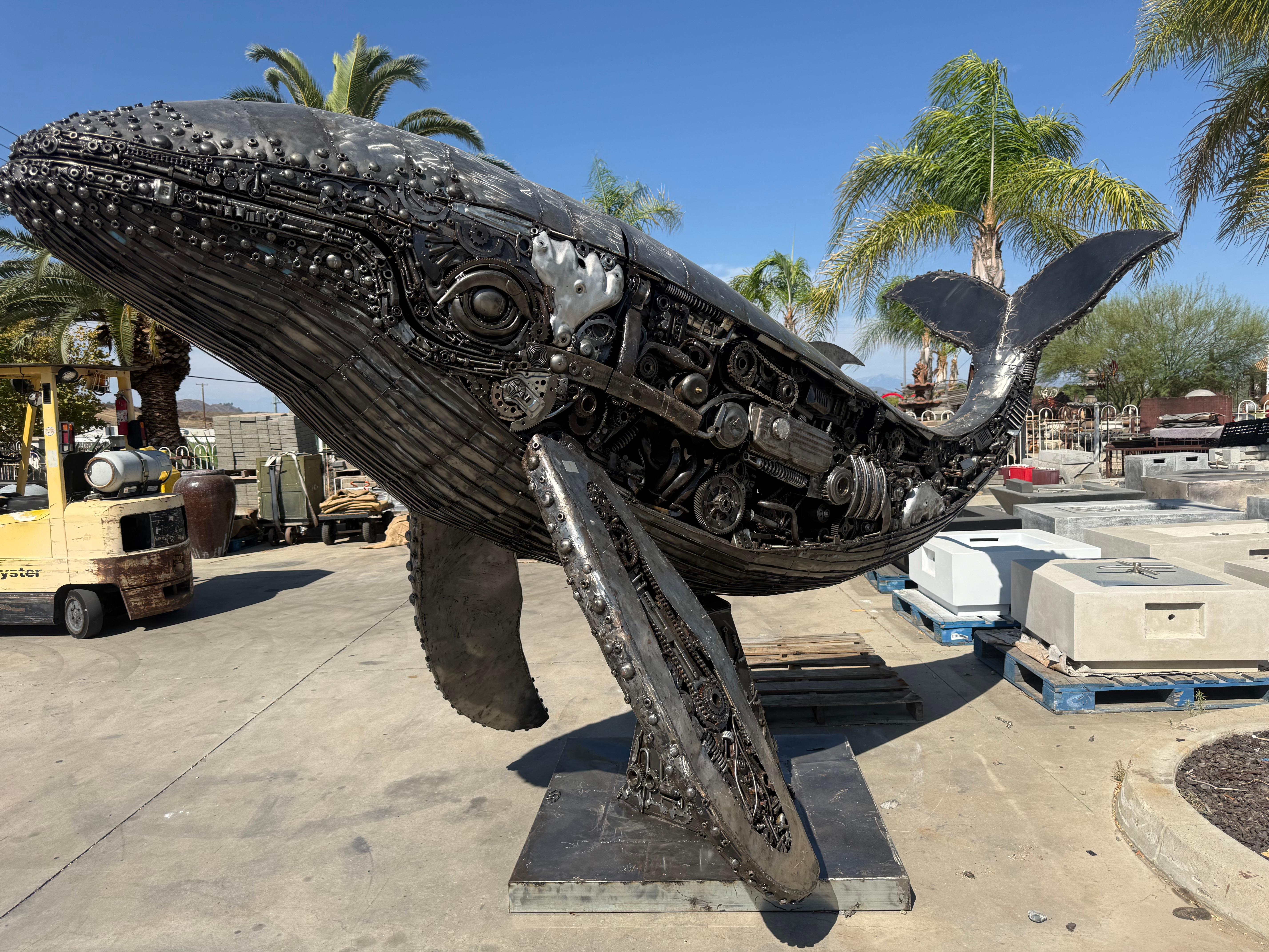 Large metal whale sculpture displayed at the WaterWise showroom